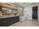 Modern bathroom featuring a standalone tub, double vanity, and sleek, wood-look accents at 5866 Boston Ct, Denver, CO 80238