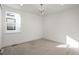 Empty bedroom with neutral carpet, a modern chandelier, and a large window with lovely views at 5866 Boston Ct, Denver, CO 80238