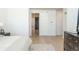 Bright bedroom featuring a sliding barn door and light hardwood floors at 5866 Boston Ct, Denver, CO 80238