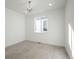 Well-lit and clean bedroom with neutral colored carpet, a chandelier, and large windows at 5866 Boston Ct, Denver, CO 80238