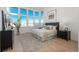 Light-filled bedroom featuring large windows, a comfortable bed, and neutral decor at 5866 Boston Ct, Denver, CO 80238