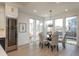 Dining area featuring large windows, wine cooler, and stylish pendant lighting at 5866 Boston Ct, Denver, CO 80238