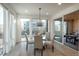 Bright dining area with large windows and sliding door to the patio at 5866 Boston Ct, Denver, CO 80238