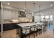 Spacious kitchen with an expansive center island, pendant lighting, and modern appliances at 5866 Boston Ct, Denver, CO 80238