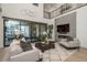 Bright living room with modern furniture, a fireplace, sliding glass doors to the backyard, and an open floor plan at 5866 Boston Ct, Denver, CO 80238