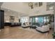 Open-concept living room featuring a modern kitchen, dining area, hardwood floors, and lots of natural light at 5866 Boston Ct, Denver, CO 80238