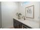 Stylish wet bar featuring marble countertop, modern faucet, and ample cabinet space at 5866 Boston Ct, Denver, CO 80238