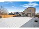 Wide snow-covered backyard with wood fencing between houses creates great outdoor living at 9421 Morning Glory Ln, Highlands Ranch, CO 80130