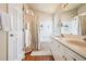 Well-lit bathroom featuring a double sink vanity and a shower/tub combination with curtain at 9421 Morning Glory Ln, Highlands Ranch, CO 80130