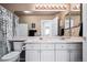 Bathroom featuring a double sink vanity, shower with curtain, and modern fixtures and lighting at 9421 Morning Glory Ln, Highlands Ranch, CO 80130