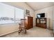 A cozy bedroom with a rocking chair, dresser, and television stand, perfect for relaxing at 9421 Morning Glory Ln, Highlands Ranch, CO 80130