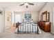 Bright bedroom features carpet floors, neutral walls, queen bed, dresser and ensuite bathroom at 9421 Morning Glory Ln, Highlands Ranch, CO 80130