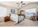 Inviting bedroom with vaulted ceiling, carpet floors, dresser, rocking chair, and natural light at 9421 Morning Glory Ln, Highlands Ranch, CO 80130