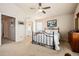 Carpeted bedroom features a queen bed, dresser, and decor with an ensuite bathroom at 9421 Morning Glory Ln, Highlands Ranch, CO 80130