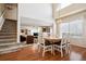 Bright dining area with hardwood floors and view of living room and stairs at 9421 Morning Glory Ln, Highlands Ranch, CO 80130