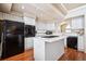 Modern kitchen featuring white cabinetry, black appliances, and a functional center island at 9421 Morning Glory Ln, Highlands Ranch, CO 80130