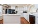 Modern kitchen featuring white cabinetry, black appliances, and a functional center island at 9421 Morning Glory Ln, Highlands Ranch, CO 80130