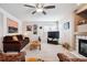 Cozy living room features a ceiling fan, fireplace, carpet floors, and lots of natural light at 9421 Morning Glory Ln, Highlands Ranch, CO 80130