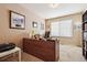 Bright home office space featuring a large desk, ample natural light, and built-in bookshelves at 9421 Morning Glory Ln, Highlands Ranch, CO 80130