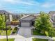 Aerial view of a charming single-Gathering home with two-car garage, stone accents and a well-kept lawn at 9628 Albion Ln, Thornton, CO 80229