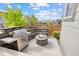 Outdoor patio featuring a built-in grill, fire pit, and stone seating area perfect for entertaining guests and outdoor dining at 9628 Albion Ln, Thornton, CO 80229