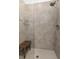 Bathroom features a walk in tiled shower, glass door, and wooden bench at 9628 Albion Ln, Thornton, CO 80229