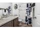 Stylish bathroom with a shower-tub combo and a granite countertop sink at 9628 Albion Ln, Thornton, CO 80229