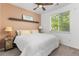 Cozy bedroom with a ceiling fan and natural light from the window at 9628 Albion Ln, Thornton, CO 80229