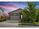 Charming single-Gathering home with a two-car garage, stone accents, a well-kept lawn and a picturesque sunset backdrop at 9628 Albion Ln, Thornton, CO 80229