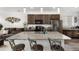 Open concept kitchen features a large island, granite countertops, stainless steel appliances, and dark wood cabinetry at 9628 Albion Ln, Thornton, CO 80229