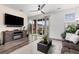Bright living room with a sliding glass door, a fireplace, and wood flooring at 9628 Albion Ln, Thornton, CO 80229