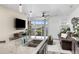 Cozy kitchen/living area combo with granite counters, ceiling fan, and sliding glass doors at 9628 Albion Ln, Thornton, CO 80229