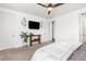 Cozy main bedroom features lots of natural light, carpet, and tv at 9628 Albion Ln, Thornton, CO 80229