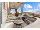 Covered patio featuring a gas grill, sitting area, and a modern fire pit at 9628 Albion Ln, Thornton, CO 80229
