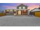 Home's backyard with covered patio, exterior brickwork, and wintery snow-covered lawn at 14126 W Harvard Pl, Lakewood, CO 80228