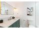 Bathroom with vanity and modern faucet, accent mirror, and crisp subway tile in shower at 14126 W Harvard Pl, Lakewood, CO 80228