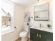 Well lit bathroom with new toilet, vanity and sink, and modern mirror at 14126 W Harvard Pl, Lakewood, CO 80228