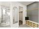 Modern bathroom with a walk-in shower, modern mirror, and shelving at 14126 W Harvard Pl, Lakewood, CO 80228