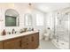 Modern bathroom with double vanity and a large glass walk-in shower at 14126 W Harvard Pl, Lakewood, CO 80228