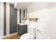 Charming half bath with gray and white accents, wood shelf, mirror, and modern fixtures at 14126 W Harvard Pl, Lakewood, CO 80228