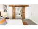 Modern bedroom with neutral paint and wood sliding doors to Primary bath at 14126 W Harvard Pl, Lakewood, CO 80228