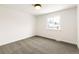 Empty bedroom with plush carpet, neutral paint, and large window at 14126 W Harvard Pl, Lakewood, CO 80228