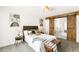 Bedroom featuring rustic sliding barn doors into a light, modern bathroom at 14126 W Harvard Pl, Lakewood, CO 80228