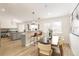 Bright dining area with modern lighting fixtures and open view to the kitchen at 14126 W Harvard Pl, Lakewood, CO 80228