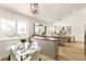 Bright dining area features a modern glass table with views to the kitchen and backyard at 14126 W Harvard Pl, Lakewood, CO 80228