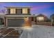 Two-story home with brick and gray siding, two car garage, and snow-covered front yard at 14126 W Harvard Pl, Lakewood, CO 80228