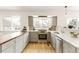 Well-lit kitchen boasts stainless appliances, wood counters, white countertops, and streamlined cabinets for a functional space at 14126 W Harvard Pl, Lakewood, CO 80228