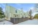 Tan siding, snow covered yard and wooden fence at 19921 Victorian Way, Parker, CO 80138