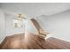 Bright living room with hardwood floors and a view of the kitchen and staircase at 19921 Victorian Way, Parker, CO 80138