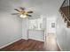 Open concept living room, kitchen and staircase with hardwood floors at 19921 Victorian Way, Parker, CO 80138